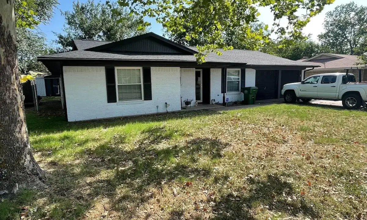Professional roofing crew working on a residential roof in Portales